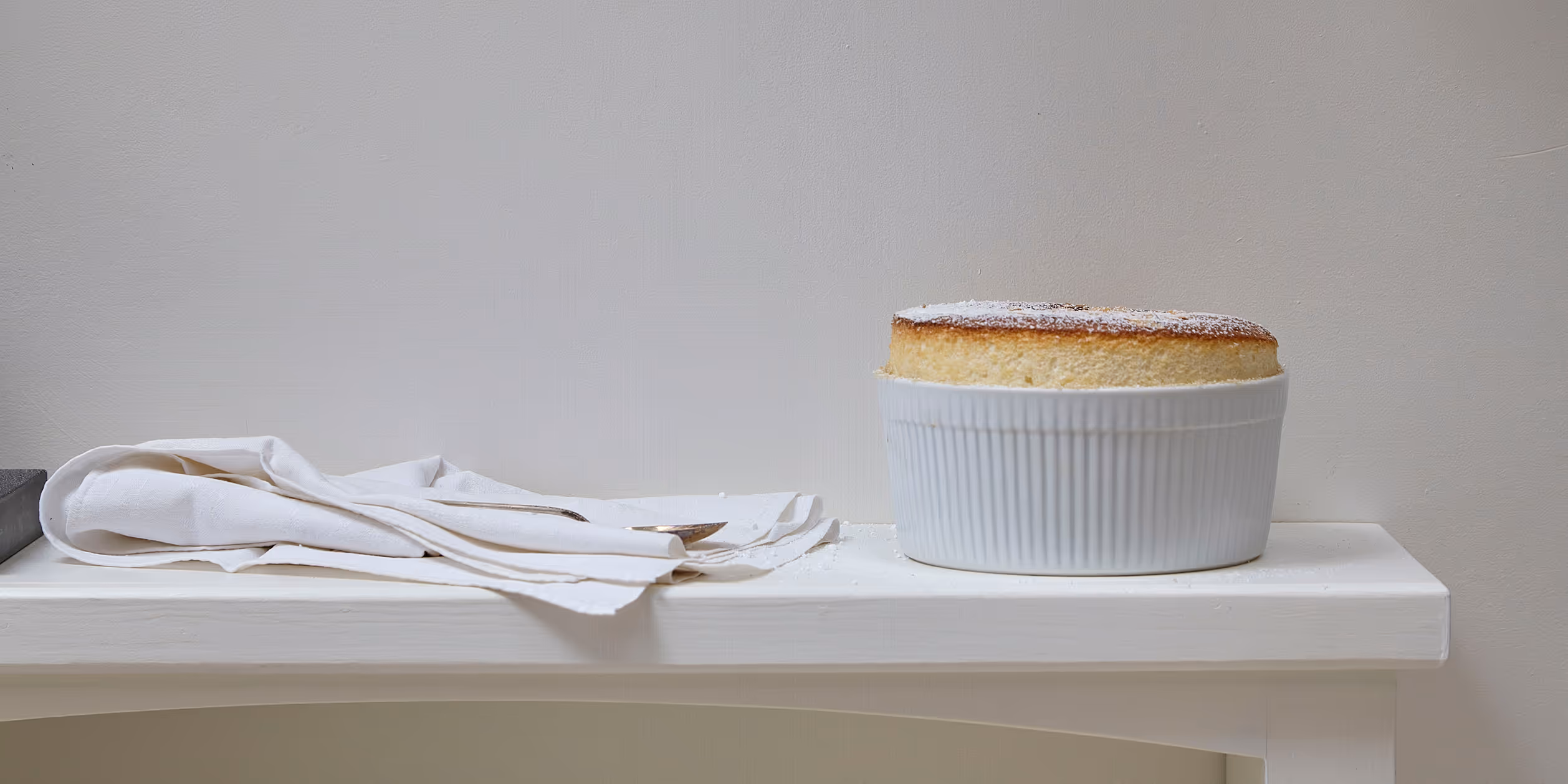Soufflé rising in a white ramekin