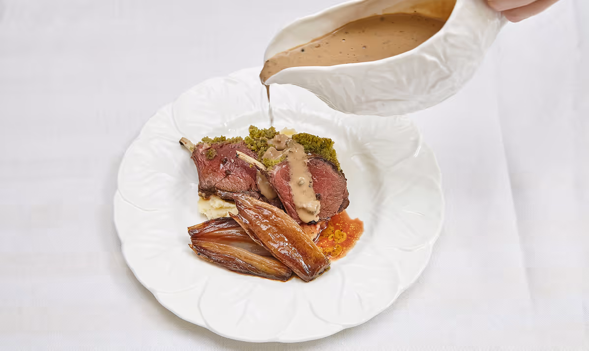 Plated lamb with jus and shallots